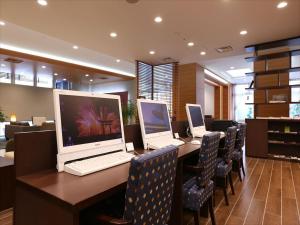 a computer desk with two laptops on it at Almont Hotel Kyoto in Kyoto