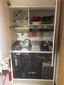 a kitchen with a sink and a dishwasher at Colle Sul Lago in Cingoli