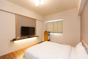 Postel nebo postele na pokoji v ubytování Huang Tai Hotel + 4 fotografie