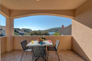 a balcony with a table and chairs with a view at Holiday Home Mirna Vala in Sevid