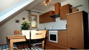 a kitchen with a table and a kitchen with a staircase at Ferienhaus Feuerer in Obertraun