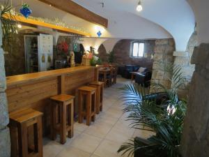 a restaurant with a bar with wooden tables and benches at The Blue Beetroot in Bolesławiec
