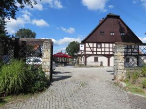 an old barn with a gate and a building at The Blue Beetroot in Bolesławiec