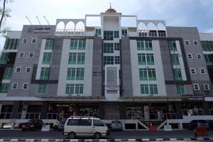 a building with a van parked in front of it at Mae KB Guesthouse at Khalifa Hotel in Kota Bharu