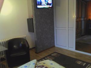 a living room with a television on a wall at Casa Mea in Eforie Nord