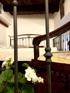 a bedroom with a bed with white flowers on the floor at La Dimora Del Professore in Naples