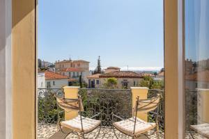 a balcony with two chairs and a view of a city at Villa Lotus Penthouse by iVillamia in Nice