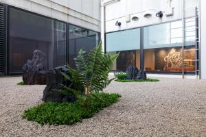 a palm tree in front of a building at Izumisano Center Hotel Kansai International Airport in Izumi-Sano