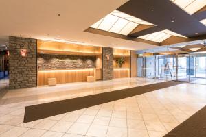 a lobby of a building with a stone wall at Izumisano Center Hotel Kansai International Airport in Izumi-Sano