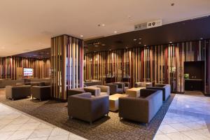 a lobby with couches and chairs in a building at Izumisano Center Hotel Kansai International Airport in Izumi-Sano