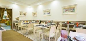 a restaurant with tables and chairs in a room at Hotel Concorde in Rome