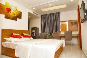 a hotel room with a bed and a dining room at 60 Inn Saigon in Ho Chi Minh City