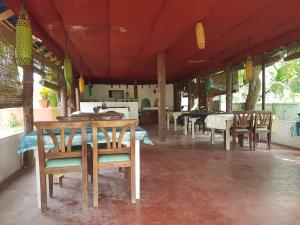 a dining room with tables and chairs in a room at Nikhil Residence in Varkala