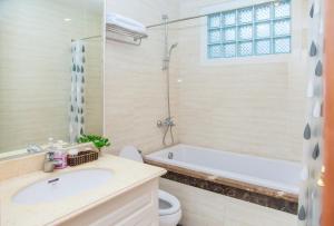 a bathroom with a sink and a tub and a toilet at Tài Tâm - Grand Spring Suites in Hanoi +49 photos