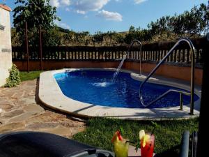 a small pool with a water slide in a yard at Centro de Turismo Rural Roqueo de Chavela in Robledo de Chavela