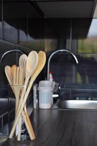a kitchen counter with wooden spoons and a sink at Apartment Bini in Molunat +16 photos