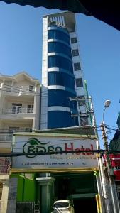 a tall building with a sign in front of it at Eden Hotel Sài gòn in Ho Chi Minh City