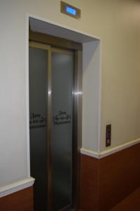 an elevator in a building with writing on the wall at Mayakovka House in Moscow