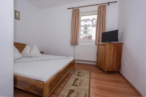 Un pat sau paturi într-o cameră la Complex Panoramic