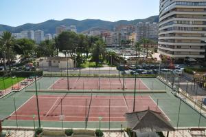 an aerial view of two tennis courts in a city at Palm Tree Cullera in Cullera