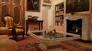 a living room with a fireplace and a table with candles at Gran Suite Piazza Maggiore - T&T communications in Bologna