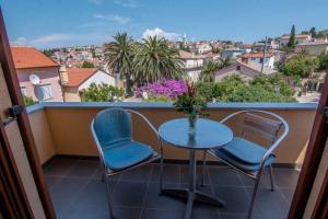 a table and chairs on a balcony with a view at Apartments Villa Forida in Mali Lošinj +11 photos