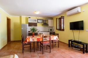 a kitchen and dining room with a table and chairs at Apartments Villa Forida in Mali Lošinj