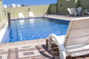 a swimming pool on the roof of a hotel at Al Mansour Park Inn Hotel&Apartment in Doha