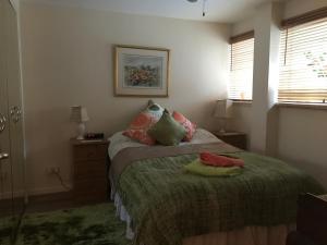 a bedroom with a bed with two towels on it at City Centre Executive Apartment - Private Parking, Gym & Sauna in Aberdeen