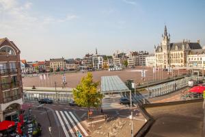 a large city with a street with buildings and a plaza at Hotel De Spiegel in Sint-Niklaas