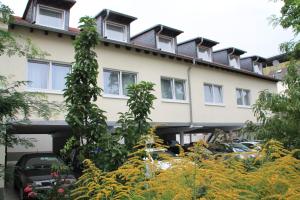 un edificio con plantas delante de él en RIESENjunior Hanau by Trip Inn, en Hanau am Main