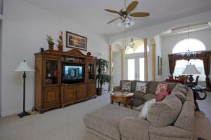 a living room with a couch and a tv at Mangrove Bay SW Cape - waterfront private home locally owned & managed, fair & honest pricing in Cape Coral