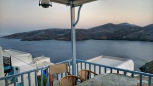 a balcony with a table and a view of the water at Traditional Holiday Home in Astypalaia Town