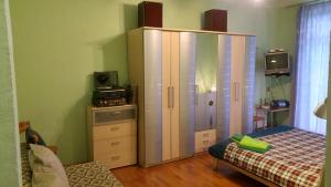 a bedroom with a large cabinet and a bed at Shievchienko 10 in Kyiv