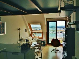 a living room with a view of the ocean at Apartamentos Puerto Basella in Villanueva de Arosa