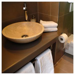 a bathroom with a wooden sink on a counter at Les logis de l'horloger in La Chaux-de-Fonds