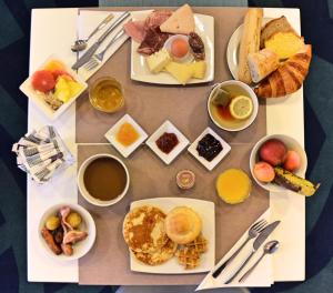 a table topped with plates of breakfast foods and drinks at Mercure Toulouse Centre Saint-Georges in Toulouse