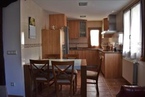 a kitchen with a table and chairs and a refrigerator at Casa Artegia in Mezkiriz