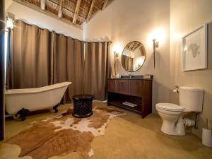 a bathroom with a tub and a toilet and a sink at Burlington Bush Cottages by The Oyster Collection in Salem