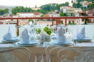a table with silverware and napkins on top of a table at Neda Hotel in Olympia