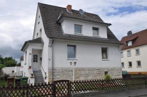 a white house with a black roof at Fewo-Fuldatal in Fuldatal