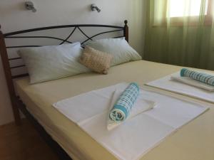 a bed with white sheets and pillows on it at Apartman Mimoz in Senj