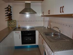 a small kitchen with a sink and a stove at Balcon del mar in Morche