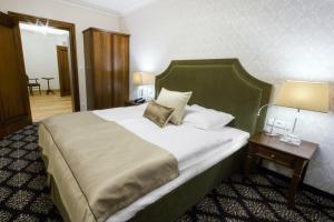 Postel nebo postele na pokoji v ubytování HG Hotel