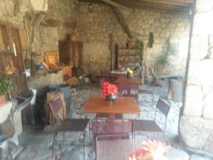 a room with tables and chairs in a stone building at Casa das Freiras in Marialva