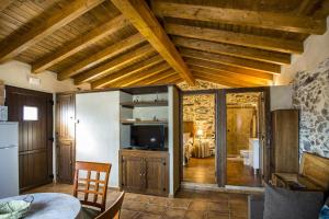 a living room with a table and a television at Los Monteros Sierra de Francia in Aldeanueva de la Sierra