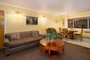 a living room with a couch and a table at Surf Motel and Gardens in Fort Bragg