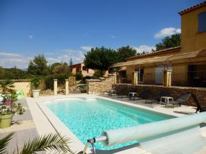 a swimming pool in front of a house at Gîte des lavandes in Montagnac