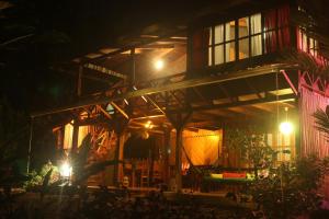 a night view of a building with lights at Casa Natural Puerto Viejo in Puerto Viejo