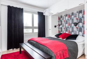a bedroom with a large bed and a red rug at Apartment Pohjanpoika in Oulu